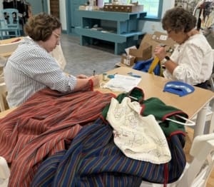 MNHS Folk Drak Project- Lucy and Barb Sewing Accession Number Labels
